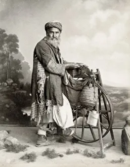 Bearded Egyptian man sharpening knives on grind stone Bearded Egyptian man sharpening knives on grind stone