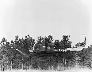 <b class=qtipBold><figcaption>Bell 204 HU-1 Iroquois Huey</figcaption></b><br>US Army Bell 204 Hu-1 Iroquois Huey Flying Firing a Ss-11 Wire-Guided Missile at Fort Rucker, Alabama, Usa Date: 1962<br><em>© aviation-images.com / Mary Evans Picture Library</em> Bell 204 HU-1 Iroquois Huey