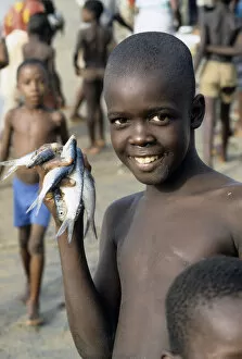 Boy with fishes, Sierra Leone