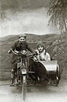 Motorcyclist Gallery: Boy & girl on a 1922 Royal Enfield motorcycle & sidecar in a