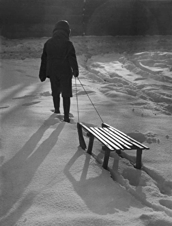 <b class=qtipBold><figcaption>Boy Pulls Sledge C1950</figcaption></b><br>A young boy pulls his sledge through the snow.<br><em>© Mary Evans Picture Library</em> Boy Pulls Sledge C1950