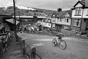 Boy pushes his bicycle up a hill in Ebbw Vale, South Wales Boy pushes his bicycle up a hill in Ebbw Vale, South Wales