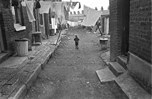 Impoverished Gallery: Boy in slum housing yard