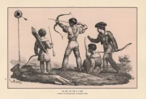 Boys firing arrows at a target in an archery Boys firing arrows at a target in an archery