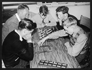 <b class=qtipBold><figcaption>Boys Play Dominoes</figcaption></b><br>Evening relaxtion at the King's Youth Hostel, Dolgelly, Wales, as dominoes and chess are played.<br><em>© Mary Evans Picture Library</em> Boys Play Dominoes