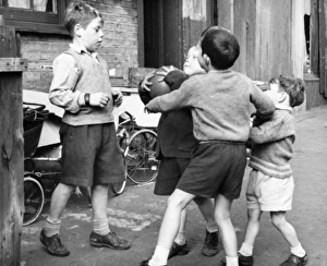 Boys playing football in a street, Balham, SW London Boys playing football in a street, Balham, SW London