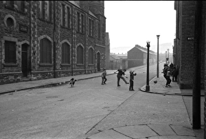 Boys playing football in a street, Belfast, Northern Ireland Boys playing football in a street, Belfast, Northern Ireland