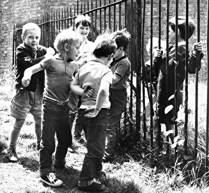 Boys playing by railings, Balham, SW London Boys playing by railings, Balham, SW London