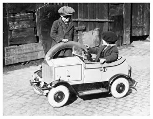 Drivers Gallery: Boys playing with toy car, 1930s