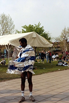 British Caribbean runner standing with wind swept foil wrap British Caribbean runner standing with wind swept foil wrap