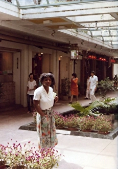 British Caribbean woman by a floral arrangement, Hong Kong British Caribbean woman by a floral arrangement, Hong Kong