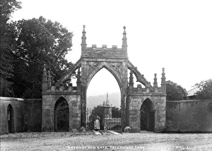 Prints of Bryansford Gate, Tullymore Park, Co. Down - with woman behind gate. (Location: Northern Ireland: County Down: Bryansford). Date: circa early 1900s Down Prints: Early 20th Century Print of Bryansford Gate, Co. Down