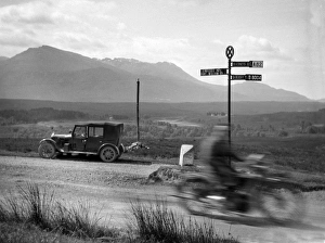 Car and motorbike passing on a road, Scotland Car and motorbike passing on a road, Scotland
