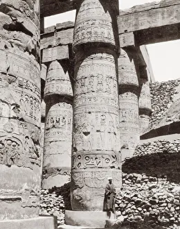 Carved pillar ancient ruins, Egypt, with figure Carved pillar ancient ruins, Egypt, with figure