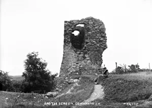 Prints of Castle Screen, Downpatrick - a view of a derelict stump of a castle with a lady sitting to the right. (Location: Northern Ireland; County Down; Downpatrick). Date: circa early 1900s Down Prints: Downpatrick Castle Screen Print, circa early 1900s
