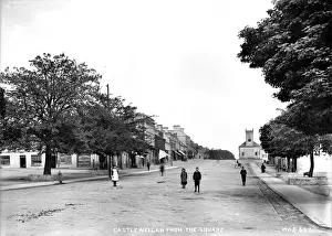 Prints of Castlewellan from the Square - a street scene showing Main street and Church to the right, with children in the foreground. (Location: Northern Ireland: County Down: Castlewellan) Down Prints: Castlewellan Street Scene Print, Early 1900s