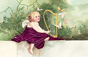 Cherub playing a harp on a greetings postcard Cherub playing a harp on a greetings postcard
