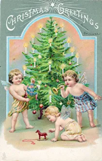 Cherubs with tree and presents on a Christmas postcard Cherubs with tree and presents on a Christmas postcard