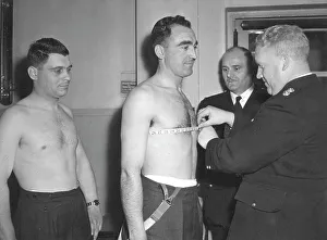 <b class=qtipBold><figcaption>Chest measurement of LFB applicant</figcaption></b><br>An LFB applicant has his chest measured by A D O Packer, commandant of the Training School. The brigade minimum is 36 inches with a two-inch expansion.<br><em>© London Fire Brigade / Mary Evans Picture Library</em> Chest measurement of LFB applicant