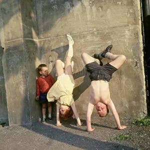 Childhood Gallery: Children doing handstands on a Balham street, SW London