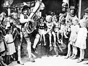 Children listening to a tuba player, Berlin, 1945 Children listening to a tuba player, Berlin, 1945