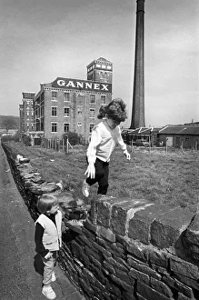 Children play outside the old Gannex factory in Elland Children play outside the old Gannex factory in Elland