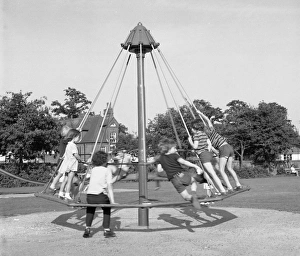 Children playing on an umbrella roundabout Children playing on an umbrella roundabout