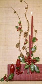 Christmas arrangement of candles, holly and pine cones Christmas arrangement of candles, holly and pine cones