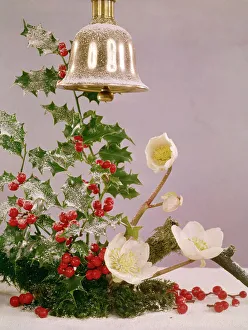 Christmas arrangement of holly, flowers and bell Christmas arrangement of holly, flowers and bell