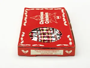 <b class=qtipBold><figcaption>Christmas crackers in box</figcaption></b><br>Cracker box printed in red and white, with a cut-out window revealing twelve unused Christmas crackers, manufactured in England c.1960-1970. Date: c.1960-1970<br><em>© The Geffrye Museum of the Home / Mary Evans Picture Library</em> Christmas crackers in box