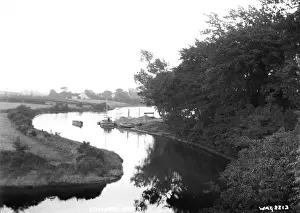 Prints of Comber River - a view of a meandering river, with boats on it. (Location: Northern Ireland; County Down; Comber). Date: circa early 1900s Down Prints: Comber River Print - Early 20th Century Watercolour