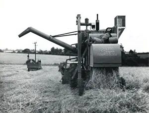 Combine harvester at work in a field, Cornwall Combine harvester at work in a field, Cornwall