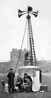 <b class=qtipBold><figcaption>The coming of the 'Loud speaker'</figcaption></b><br>Photograph of a loud speaker being used at Stamford Bridge football stadium. The man seated at the table spoke into the telephone receiver and his voice was broadcast through the six speakers to the spectators.<br><em>© Mary Evans Picture Library 2015 - https://copyrighthub.org/s0/hub1/creation/maryevans/MaryEvansPictureID/10216065</em> The coming of the 'Loud speaker'