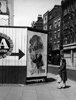 Contemplating a nutritional advice poster in London, 1940s Contemplating a nutritional advice poster in London, 1940s