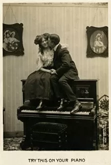 Canoodling Gallery: Couple canoodling on a piano