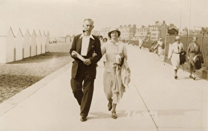 Couple on holiday stroll along the promenade at Felixstowe Couple on holiday stroll along the promenade at Felixstowe