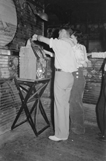 Couple playing slot machine, Raceland, Louisiana Couple playing slot machine, Raceland, Louisiana