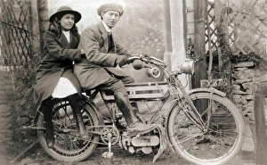 Couple sitting on 1905 Triumph motorcycle Couple sitting on 1905 Triumph motorcycle