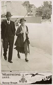 Couple strolling down a street in Worthing - Sunny Snaps