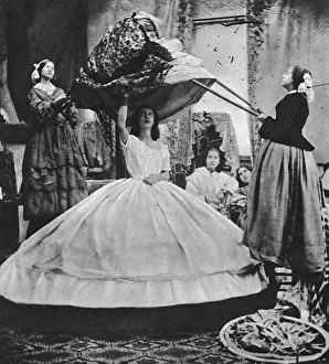Prints of A lady goes to extreme lengths to wear the widest, most fashionable crinoline skirt during the 1860s when the fashion was at its height. Date: 1865-70 Victorian Fashion Trend Prints: Crinoline Difficulties, 1860s Fashion Print, circa 1865-70
