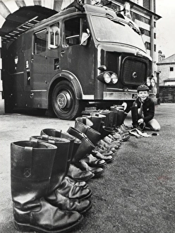 Cub Scout cleaning firemens boots, Surrey Cub Scout cleaning firemens boots, Surrey