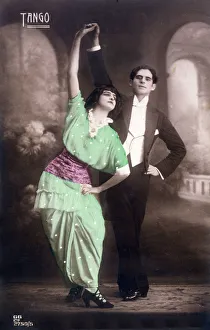 Two dancers pose for the camera with arms aloft... Date: 1914 Two dancers pose for the camera with arms aloft... Date: 1914