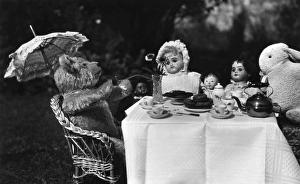 Dolls, teddy and rabbit enjoying a tea party Dolls, teddy and rabbit enjoying a tea party