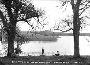 Prints of Downpatrick Cathedral and River Quoile from Inch Abbey - view from and across Quoile, with boy and girl in foreground - one fishing - to Downpatrick Cathedral River Prints: Downpatrick Cathedral and River Quoile Print, Northern Ireland