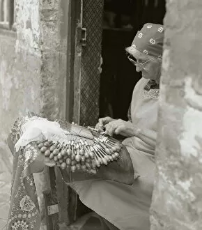 Scarf Gallery: Elderly woman making lace in an open doorway