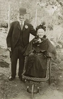 Extremely jolly elderly couple - Granny in a bath chair Extremely jolly elderly couple - Granny in a bath chair