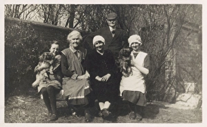 Family group with two dogs in a garden Family group with two dogs in a garden