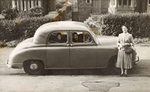 Family of three with their Singer car Family of three with their Singer car