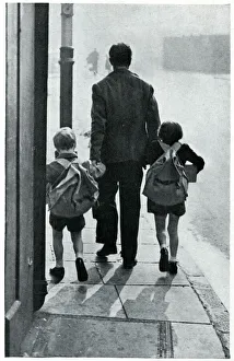 A father leads his two children to be evacuated 1939 A father leads his two children to be evacuated 1939