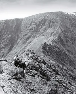 Fell walkers on Striding Edge leading to Helvellyn, Lake Dis Fell walkers on Striding Edge leading to Helvellyn, Lake Dis